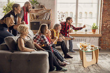 Image showing Excited, happy big family team watch football, soccer match together on the couch at home