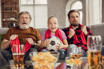 Image showing Excited, happy big family team watch football, soccer match together on the couch at home