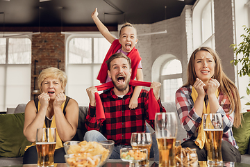 Image showing Excited, happy big family team watch football, soccer match together on the couch at home