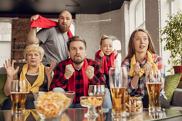 Image showing Excited, happy big family team watch football, soccer match together on the couch at home