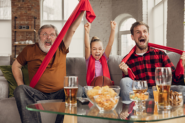 Image showing Excited, happy big family team watch sport match together on the couch at home
