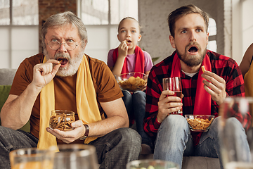 Image showing Excited, happy big family team watch football, soccer match together on the couch at home