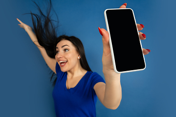 Image showing Caucasian woman\'s portrait isolated on blue studio background