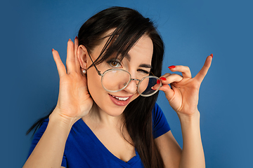 Image showing Caucasian woman\'s portrait isolated on blue studio background