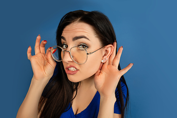 Image showing Caucasian woman\'s portrait isolated on blue studio background