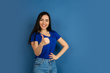 Image showing Caucasian woman\'s portrait isolated on blue studio background