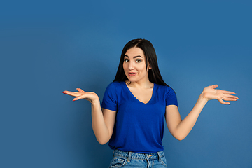 Image showing Caucasian woman\'s portrait isolated on blue studio background