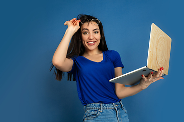 Image showing Caucasian woman\'s portrait isolated on blue studio background