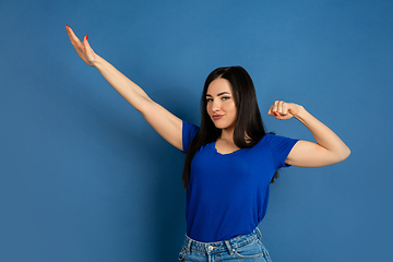 Image showing Caucasian woman\'s portrait isolated on blue studio background