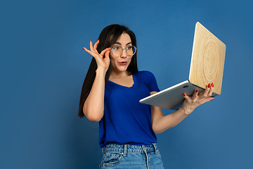 Image showing Caucasian woman\'s portrait isolated on blue studio background