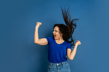 Image showing Caucasian woman\'s portrait isolated on blue studio background