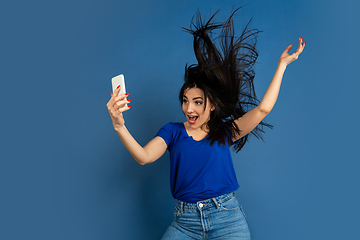 Image showing Caucasian woman\'s portrait isolated on blue studio background