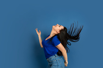 Image showing Caucasian woman\'s portrait isolated on blue studio background