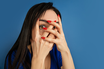 Image showing Caucasian woman\'s portrait isolated on blue studio background