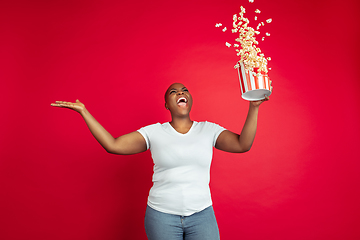 Image showing African-american young woman\'s portrait on red background