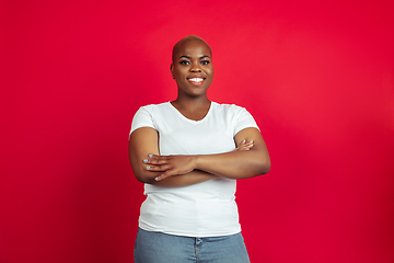 Image showing African-american young woman\'s portrait on red background