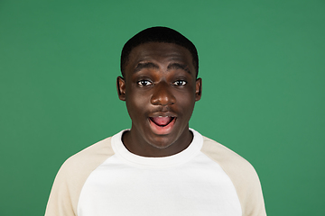 Image showing African man\'s portrait isolated on green studio background with copyspace