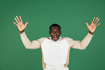 Image showing African man\'s portrait isolated on green studio background with copyspace