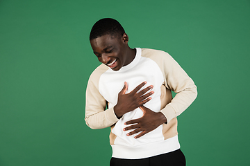 Image showing African man\'s portrait isolated on green studio background with copyspace