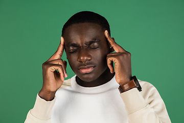 Image showing African man\'s portrait isolated on green studio background with copyspace