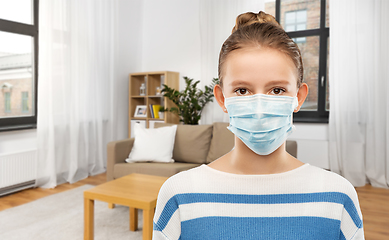 Image showing teenage girl in protective medical mask at home