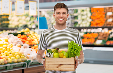 Image showing happy smiling man with food in wooden box