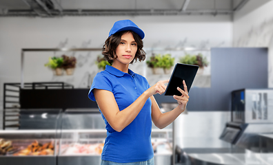 Image showing delivery girl in uniform with tablet pc at store