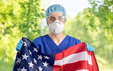 Image showing doctor in goggles and mask holding flag of america