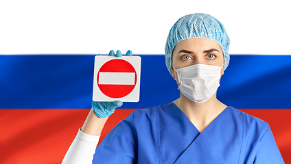 Image showing russian doctor or nurse in mask showing stop sign