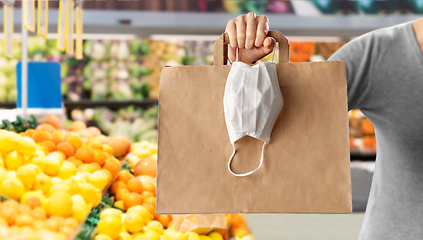 Image showing woman with shopping bag and mask at grocery