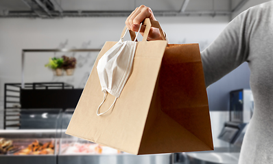 Image showing woman with food in bag and mask at grocery store