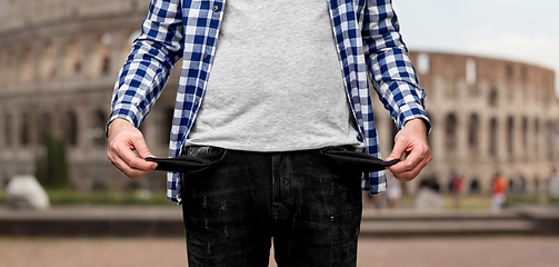 Image showing close up of man showing empty pockets in italy