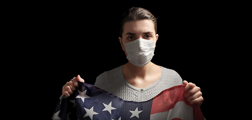 Image showing sick woman in face mask holding flag of america