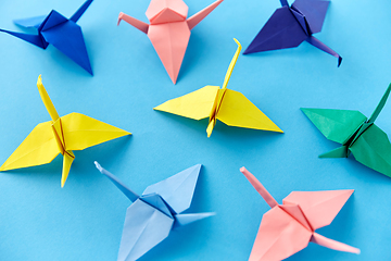 Image showing origami paper cranes on blue background