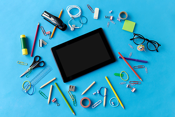 Image showing tablet pc and school supplies on blue background