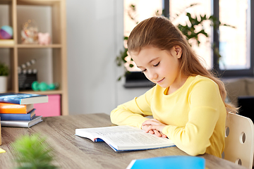 Image showing little student girl reading book at home