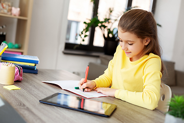 Image showing student girl writing to notebook at home