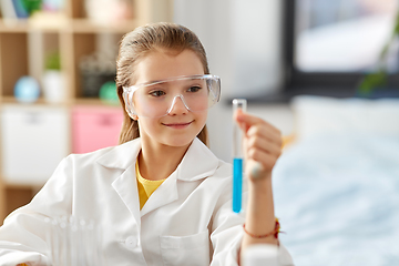 Image showing girl with test tube studying chemistry at home
