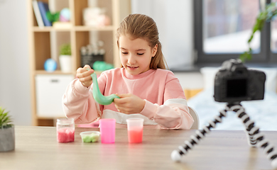 Image showing girl with slime and camera video blogging at home