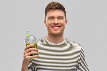 Image showing man drinking green smoothie from disposable cup