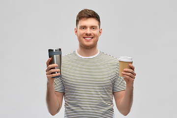 Image showing man comparing thermo cup or tumbler and coffee cup