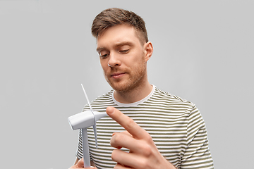 Image showing young man with toy wind turbine