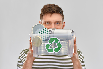 Image showing smiling young man sorting metallic waste