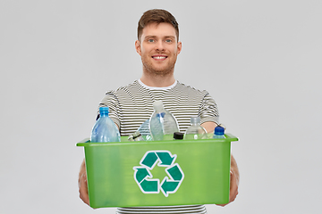 Image showing smiling young man sorting plastic waste