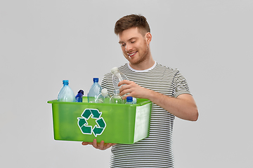 Image showing smiling young man sorting plastic waste