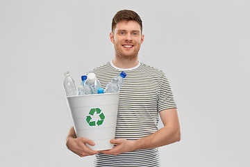 Image showing smiling young man sorting plastic waste