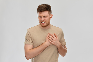 Image showing unhappy young man suffering from heartache