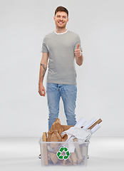 Image showing man sorting paper waste and showing thumbs up