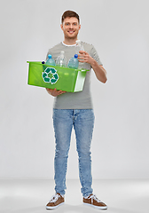 Image showing smiling young man sorting plastic waste