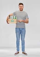 Image showing smiling young man sorting glass waste